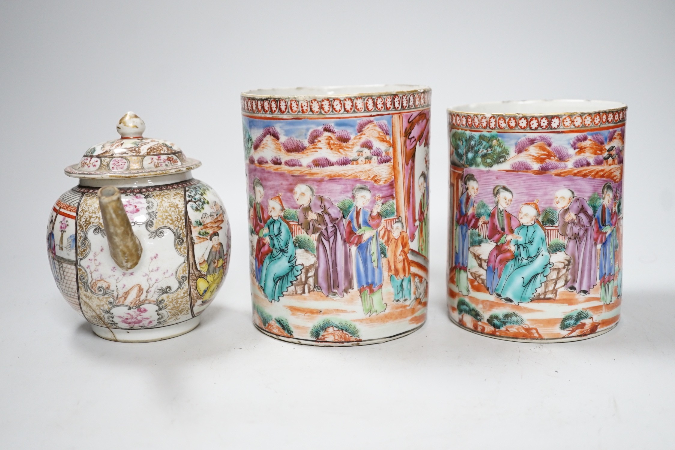 Two Chinese export 'mandarin' mugs and a similar teapot, Qianlong period, tallest mug 14cms high